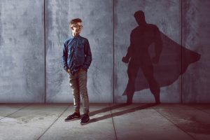 Teenage boy with superhero shadow