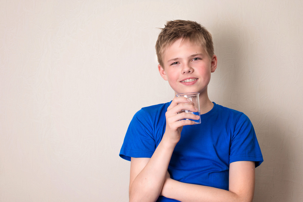Teenager with glass of water