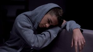 Teenager slumped over upset