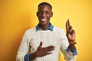 Young black male making the promises hand sign