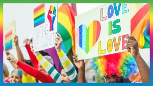 People hold love in love sign at a Pride event in England