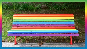 Park bench painted in the LGBT rainbow colours