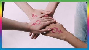 Three hands together symbolising Feminism and sisterhood